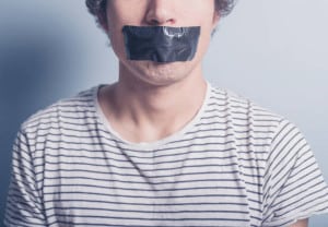 A young man has a big piece of black industrial tape covering his mouth