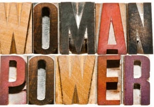 The words WOMAN POWER spelled out with vintage letterpress wood block letters.