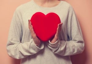 Woman holding heart shape toy as a symbol of Valentine's Day