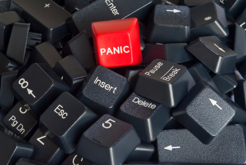 Stack of black computer keyboard keys with red panic button