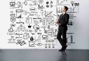 young man lookig at drawing business concept on wall