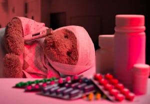 Ill teddy bear sleeping in hospital bed