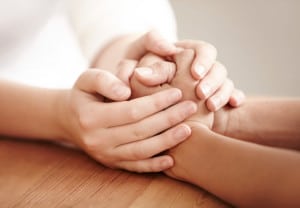Hands holding another person's hands