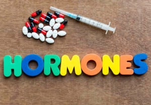 hormones colorful word in the wooden background
