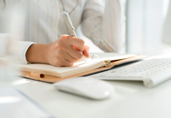 Hand of business manager making notes, selective focus