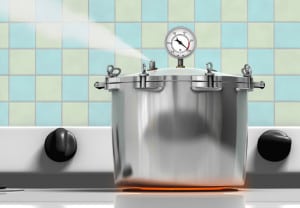 Pressure cooker ready to explode on a red hot burner