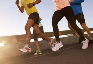 Low angle shot of a group of runners training together on the road