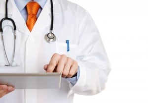 Doctor working on a digital tablet with copy space