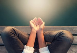 calm woman meditating reciving power by light
