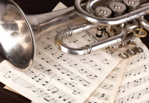 Musical notes and trumpet on wooden table